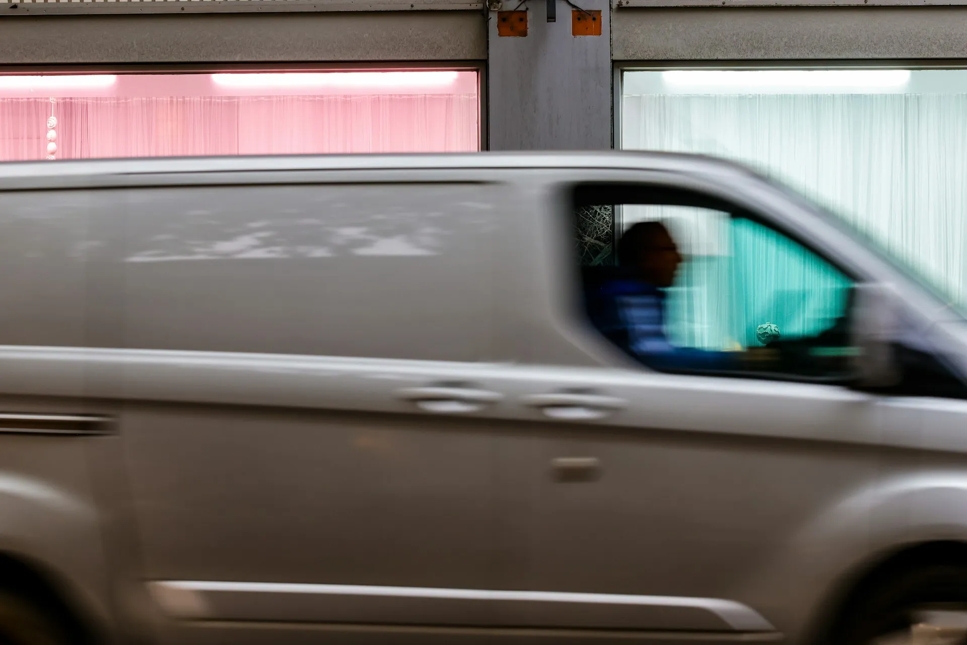 Van driving past on a city street
